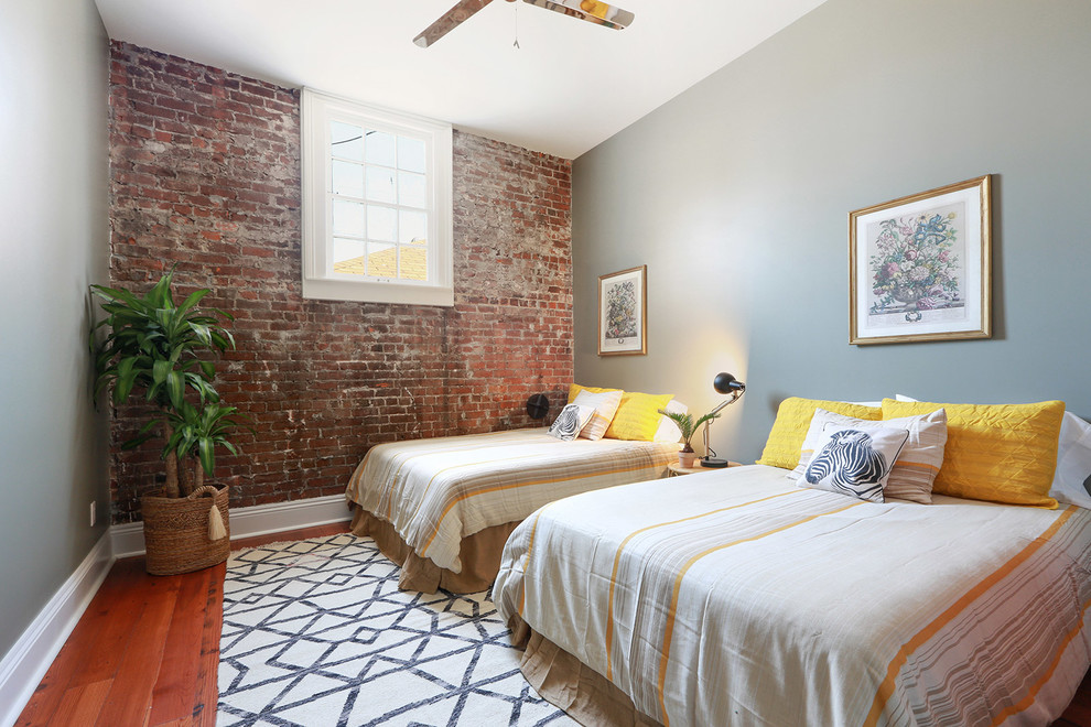 Design ideas for an urban grey and brown bedroom in New Orleans with grey walls, medium hardwood flooring and brown floors.