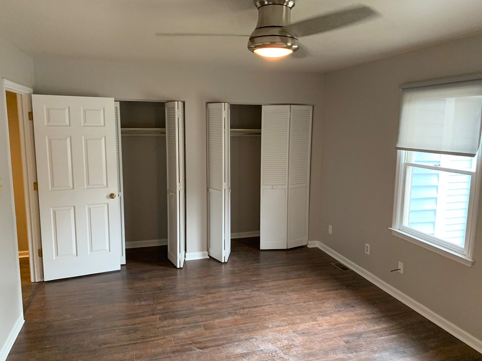 Mid-sized trendy dark wood floor and brown floor bedroom photo in Atlanta with beige walls