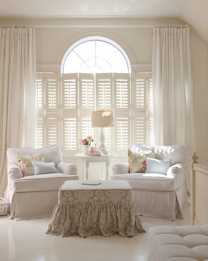 Example of a large beach style master white floor bedroom design in Tampa with white walls and no fireplace