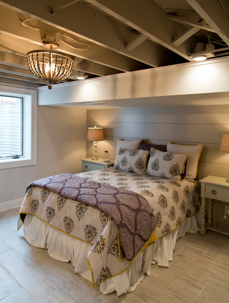 This is an example of a medium sized rural guest bedroom in Kansas City with grey walls, light hardwood flooring and grey floors.