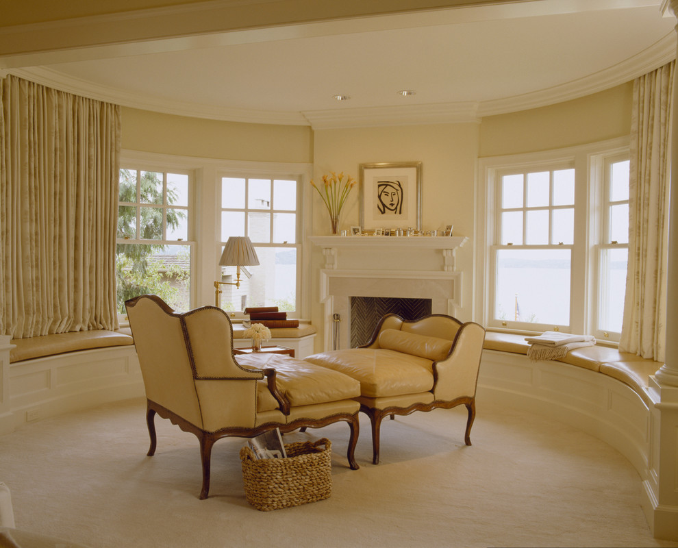 Example of a classic carpeted bedroom design in Seattle with beige walls and a standard fireplace