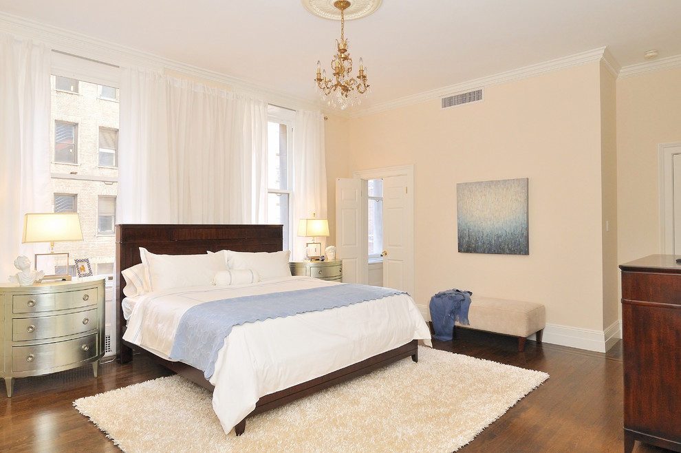 Inspiration for a classic bedroom in New York with beige walls and dark hardwood flooring.