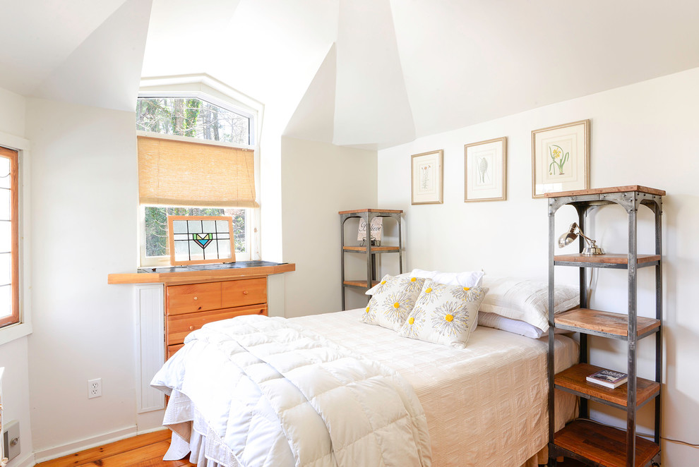 Ispirazione per una camera da letto tradizionale con pareti bianche e pavimento in legno massello medio