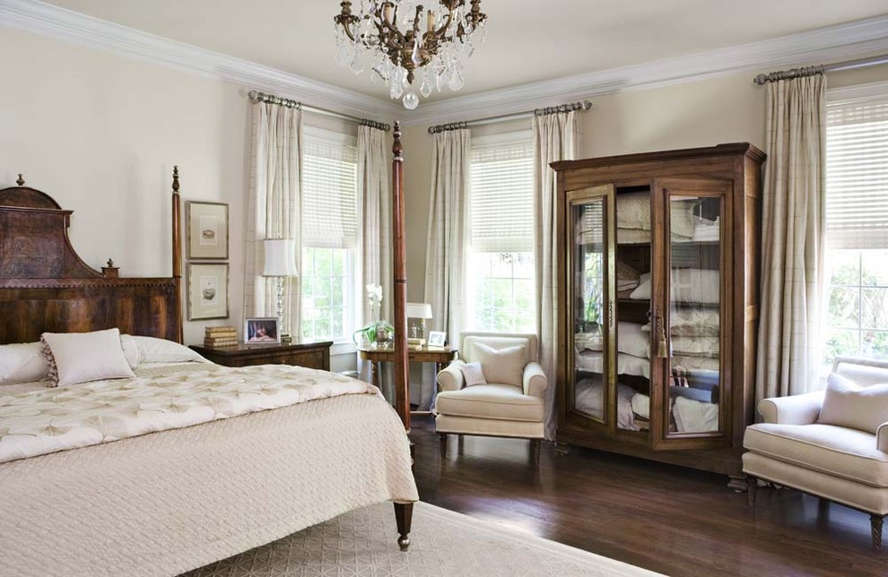 Example of a cottage chic dark wood floor bedroom design in Charleston with beige walls