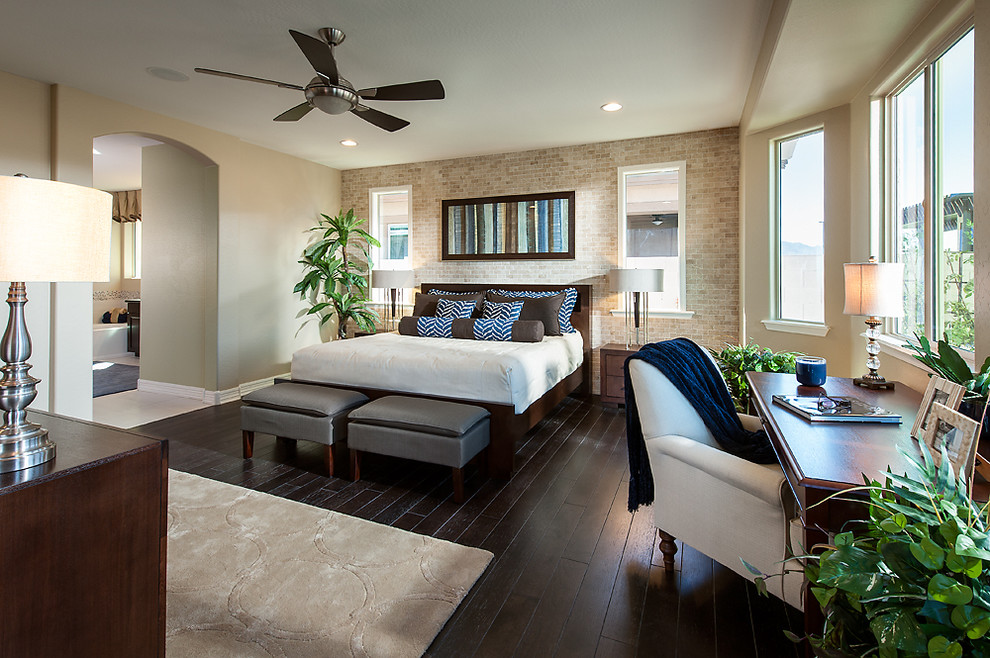 This is an example of a classic bedroom in Phoenix with beige walls and dark hardwood flooring.
