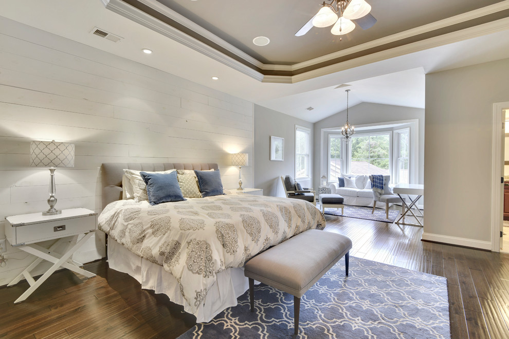 Large traditional master bedroom in Baltimore with grey walls, medium hardwood flooring and brown floors.