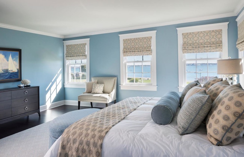 Example of a mid-sized beach style master dark wood floor bedroom design in Providence with blue walls