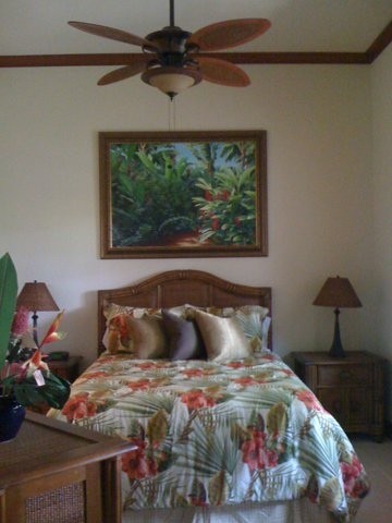 This is an example of a medium sized world-inspired bedroom in Hawaii with black walls, carpet and no fireplace.