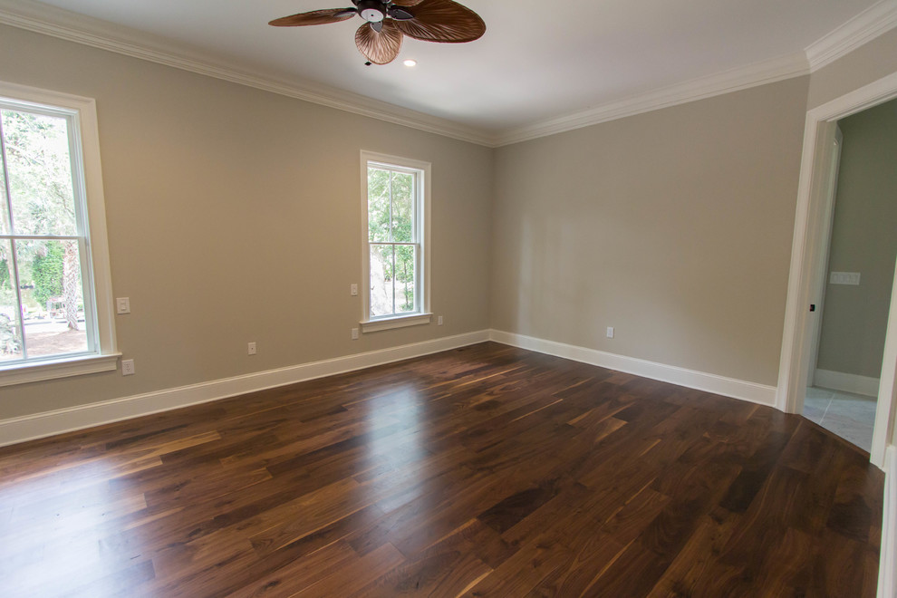Large elegant master dark wood floor bedroom photo in Charleston with beige walls