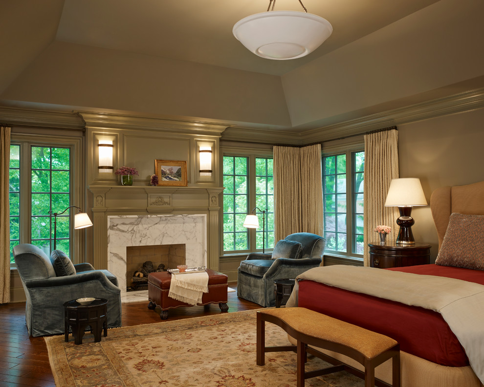 Inspiration for a large timeless master dark wood floor bedroom remodel in Chicago with beige walls, a standard fireplace and a stone fireplace