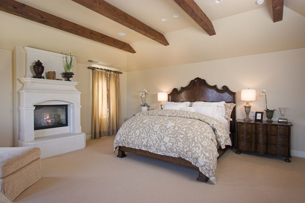 Design ideas for a large traditional bedroom in San Francisco with beige walls, carpet, a standard fireplace and a concrete fireplace surround.