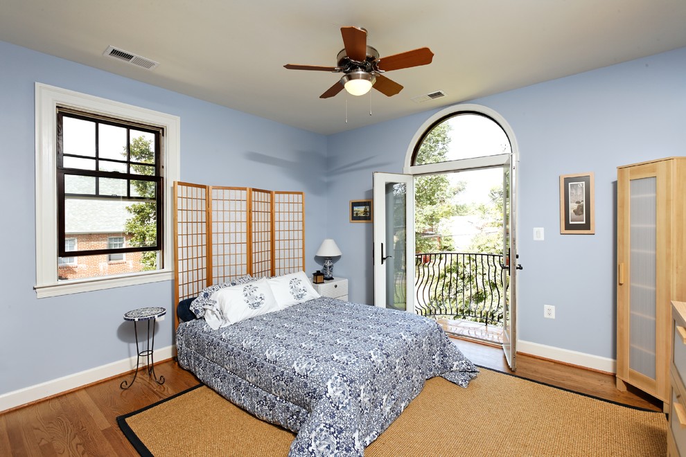 Inspiration for a small mediterranean medium tone wood floor bedroom remodel in DC Metro with blue walls