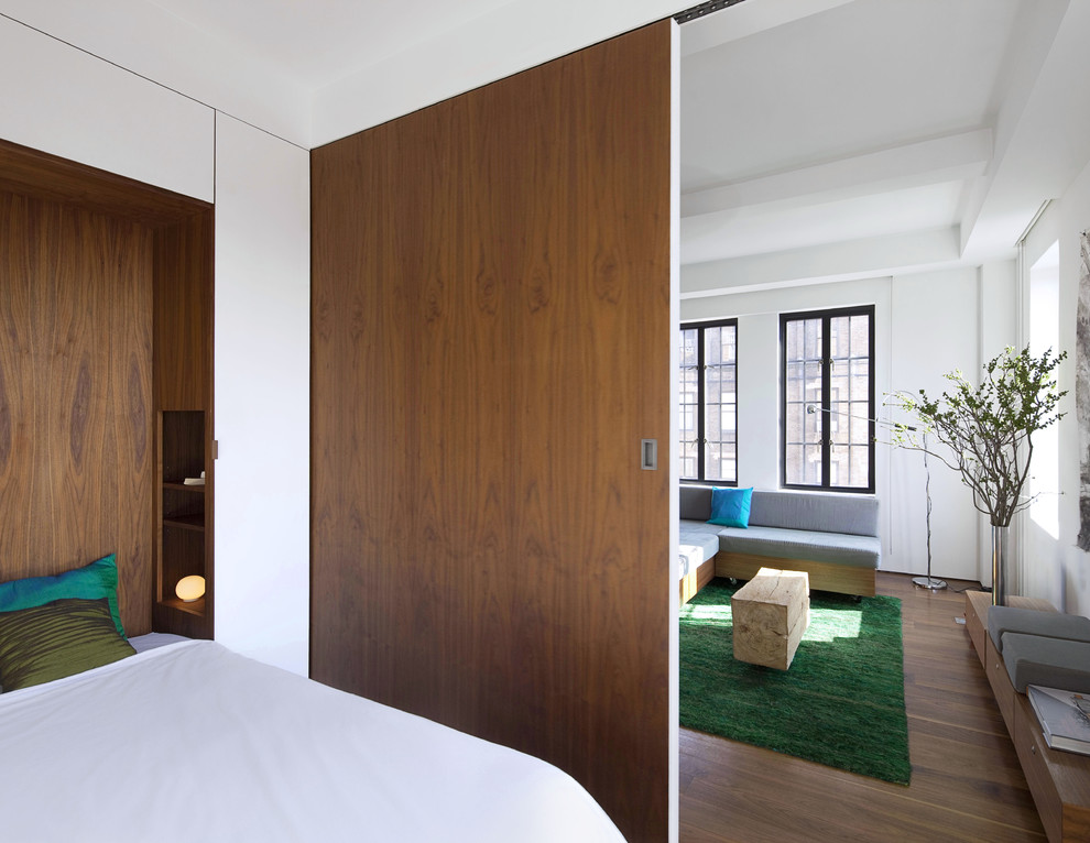 Inspiration for a modern bedroom remodel in New York with white walls