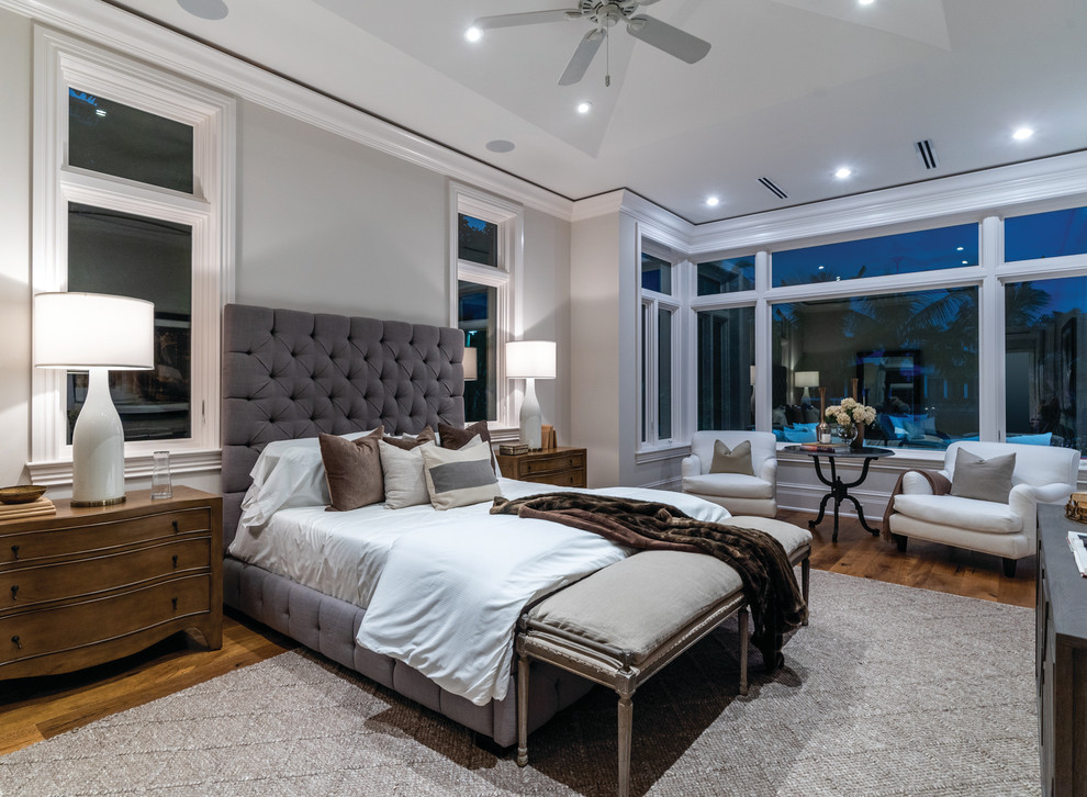 Bedroom - transitional medium tone wood floor and brown floor bedroom idea in Miami with gray walls