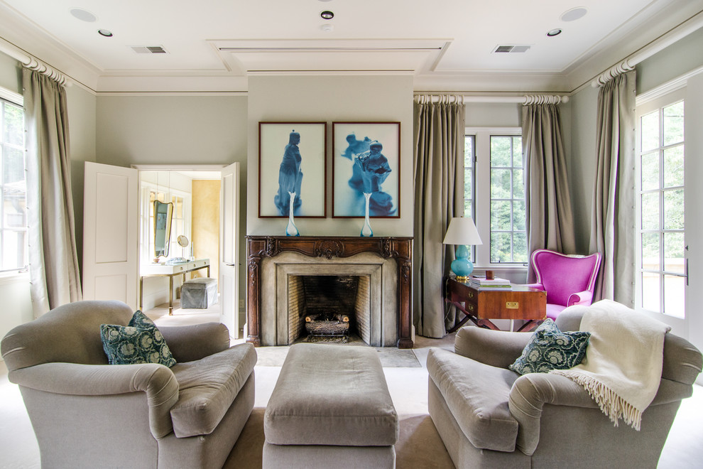 Example of a transitional bedroom design in Atlanta with gray walls and a standard fireplace