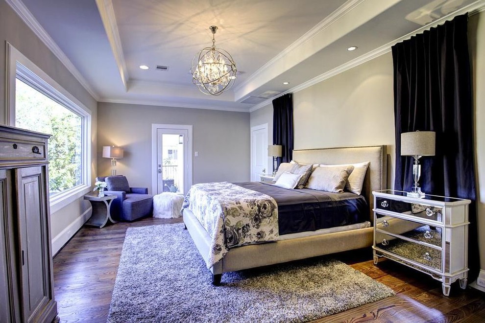 This is an example of a large classic master bedroom in Houston with beige walls, dark hardwood flooring and brown floors.