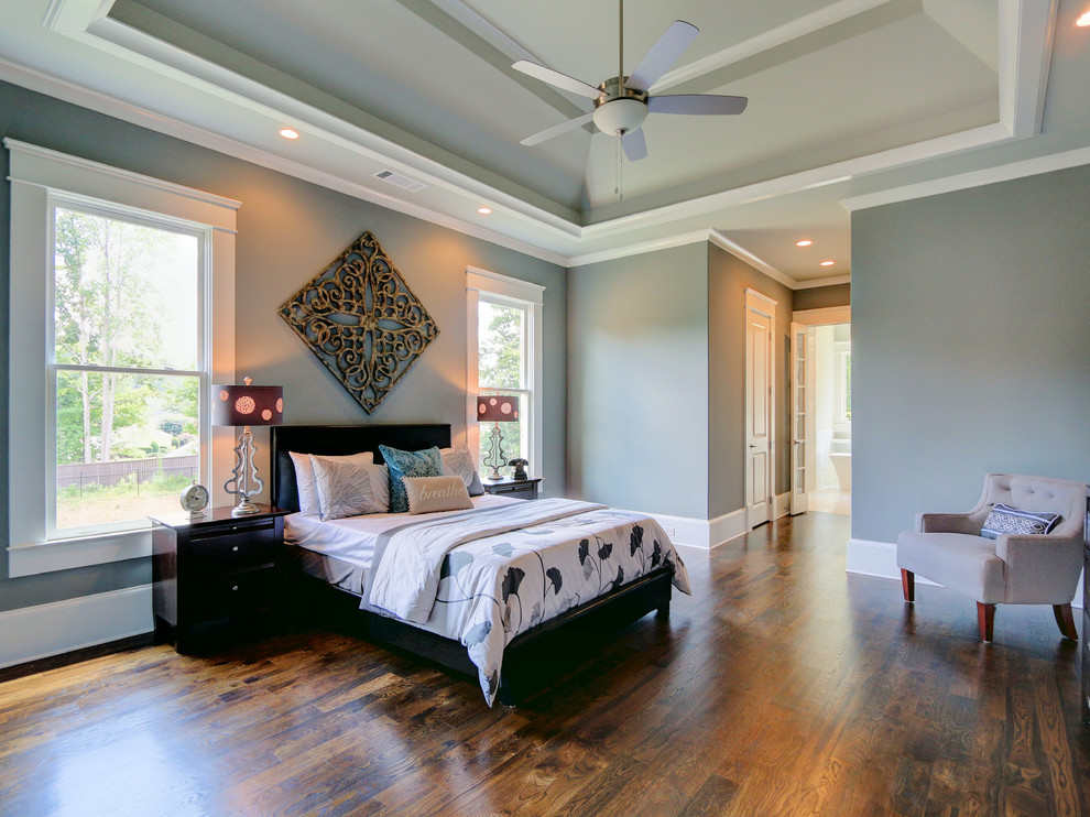 Inspiration for a mid-sized transitional master medium tone wood floor bedroom remodel in Atlanta with gray walls and no fireplace
