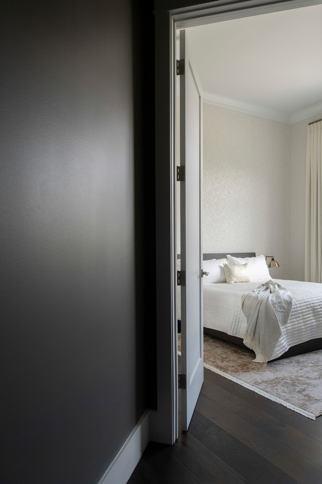 This is an example of a medium sized classic guest bedroom in Los Angeles with dark hardwood flooring, no fireplace, brown floors and beige walls.