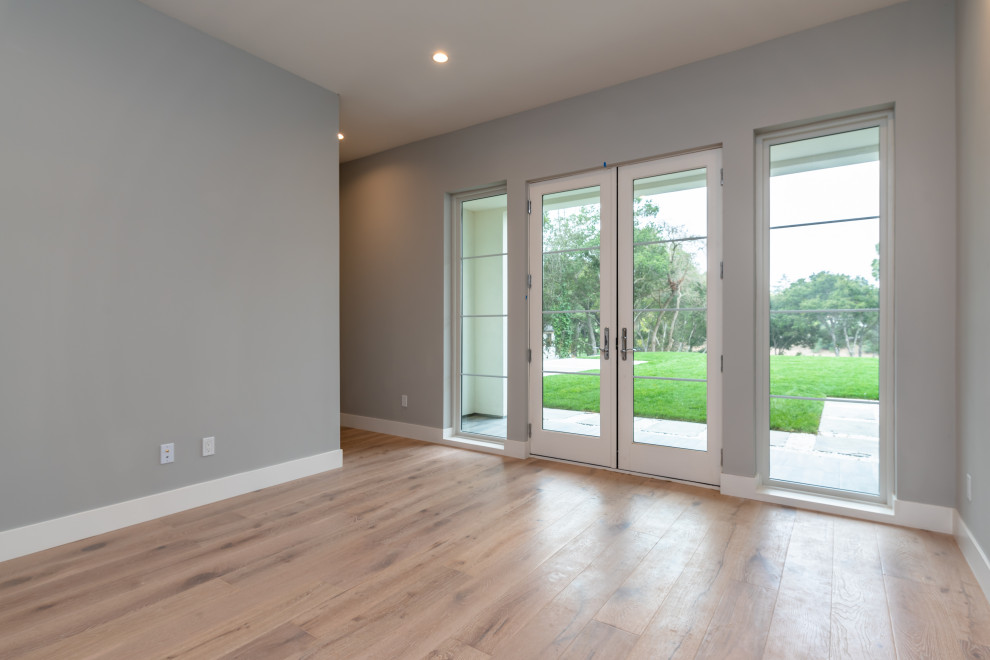 Photo of a large traditional guest bedroom in San Francisco with grey walls, light hardwood flooring and white floors.