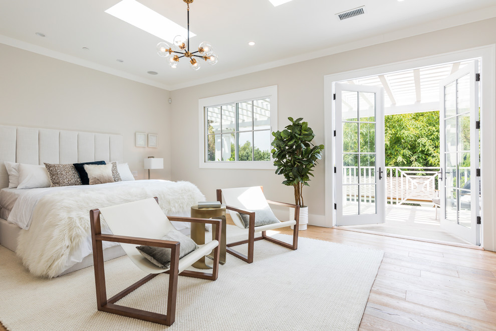 Bedroom - transitional master light wood floor bedroom idea in Los Angeles with beige walls