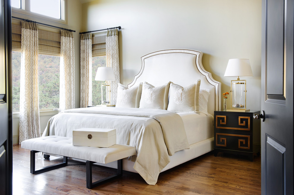 Photo of a traditional master bedroom in Other with beige walls, medium hardwood flooring and brown floors.