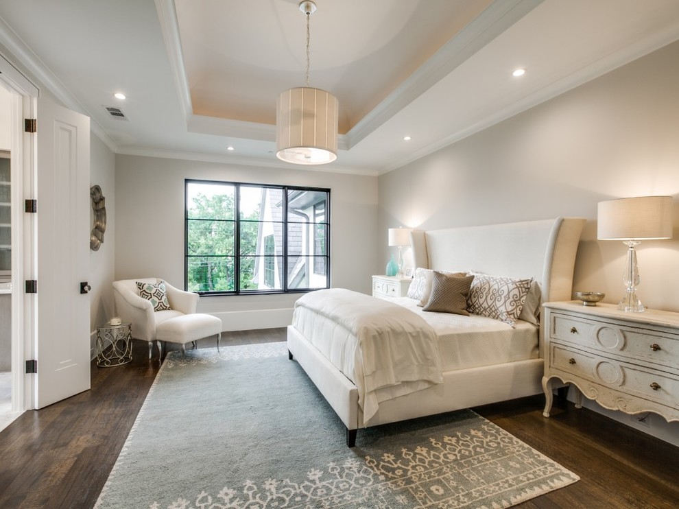 Inspiration for a large traditional master bedroom in Dallas with grey walls and medium hardwood flooring.