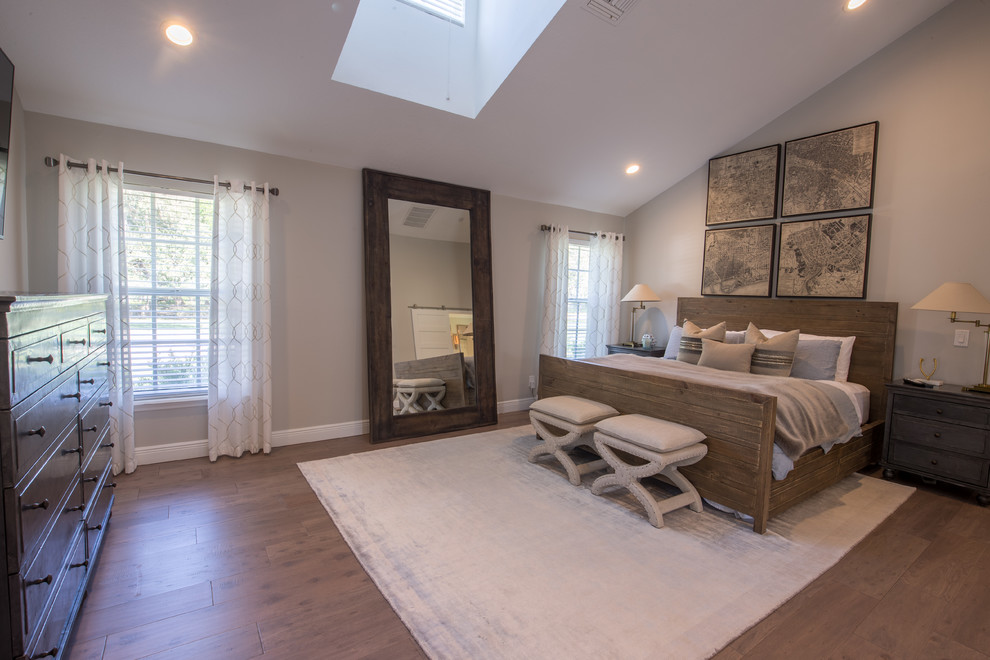 Example of a mid-sized transitional master medium tone wood floor bedroom design in Tampa with beige walls