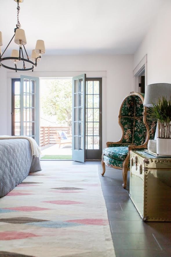Inspiration for a large traditional master bedroom in Los Angeles with white walls and ceramic flooring.