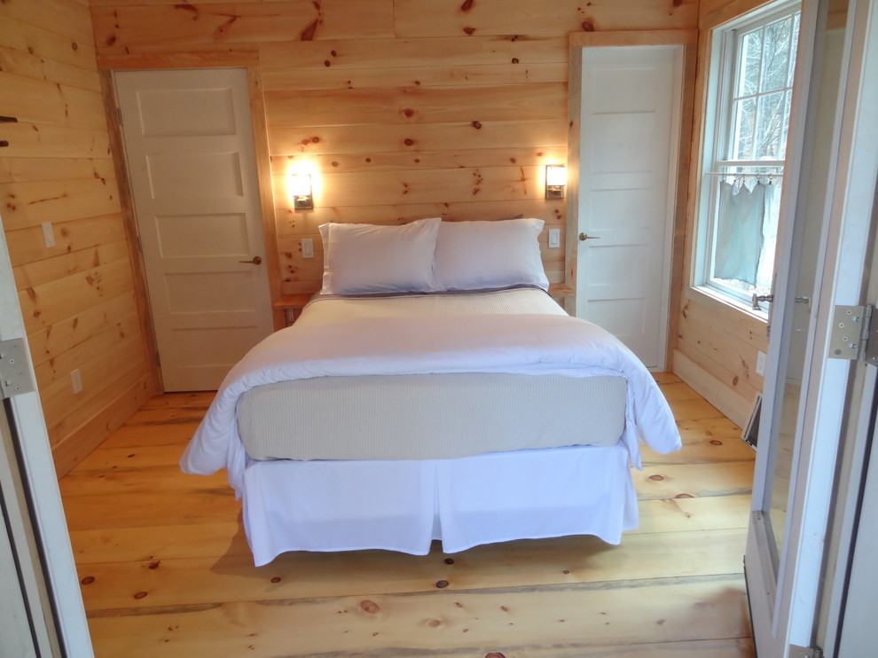Modelo de habitación de invitados rústica de tamaño medio con suelo de madera clara