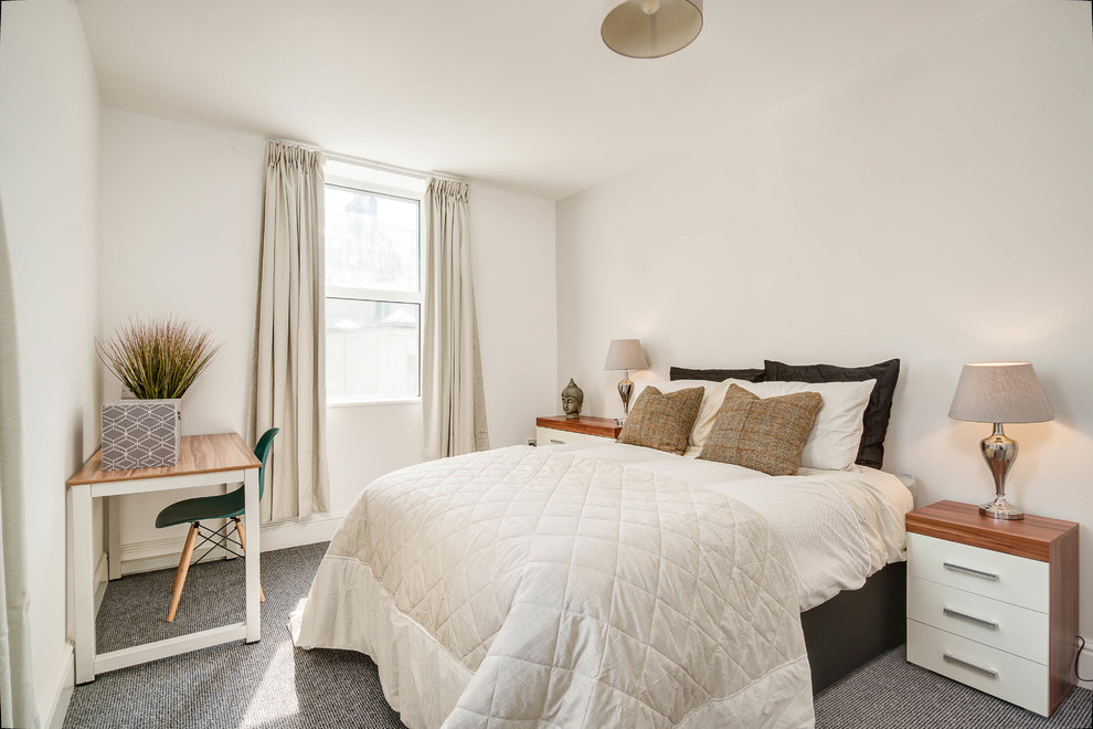 Photo of a medium sized contemporary bedroom in Devon with white walls, carpet and grey floors.