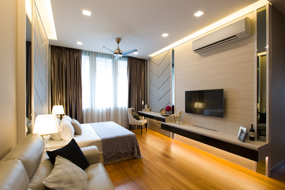 Photo of a large contemporary master bedroom in Singapore with medium hardwood flooring.