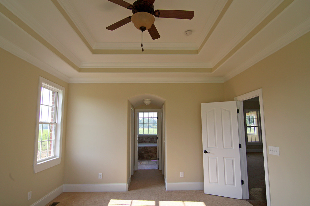 Example of a mid-sized classic master carpeted bedroom design in Raleigh with beige walls and no fireplace