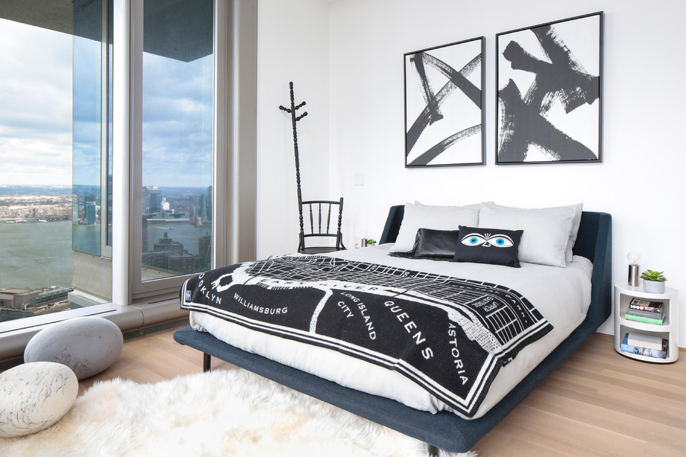 Bedroom - transitional master light wood floor bedroom idea in New York with white walls