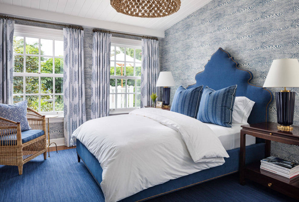 Bedroom - tropical guest medium tone wood floor and brown floor bedroom idea in Miami with blue walls