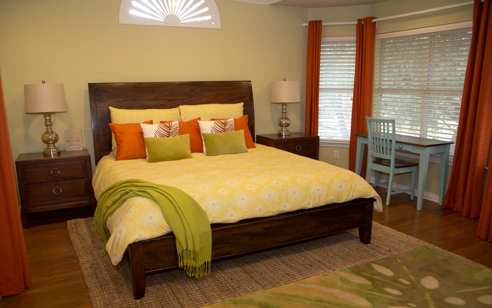 Diseño de dormitorio principal tropical de tamaño medio sin chimenea con paredes verdes, suelo de bambú y suelo marrón