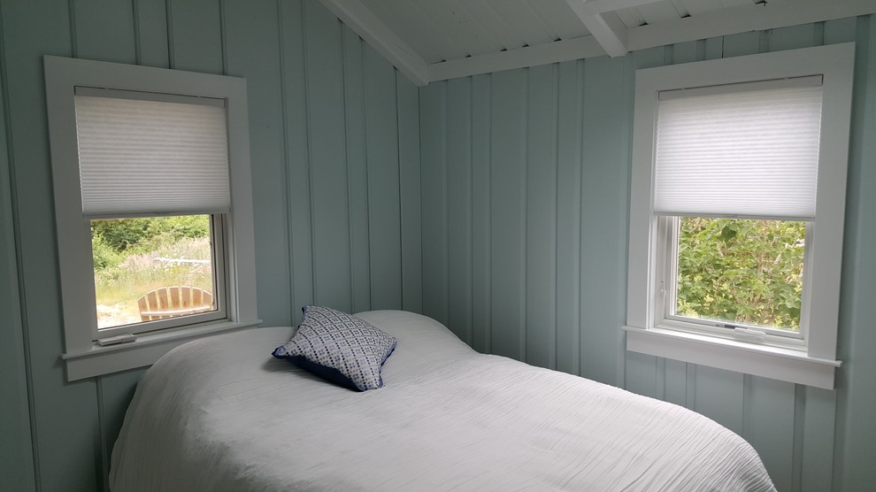 This is an example of a medium sized nautical bedroom in Boston with blue walls, medium hardwood flooring and brown floors.