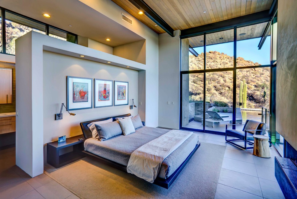 Inspiration for a contemporary master bedroom in Phoenix with grey walls and a ribbon fireplace.