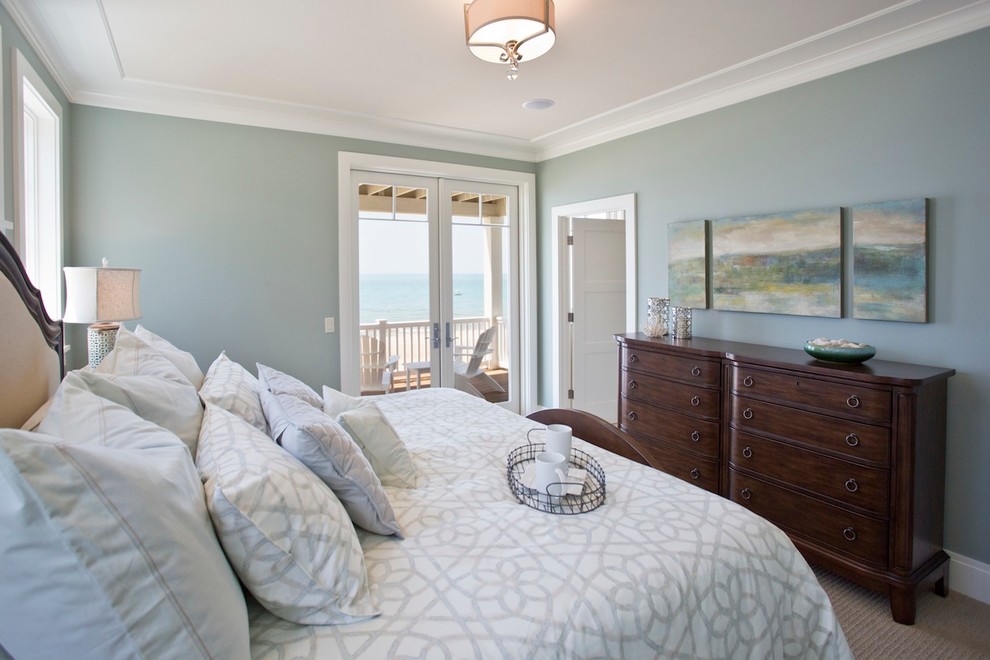 Example of a large beach style master carpeted bedroom design in Grand Rapids with green walls
