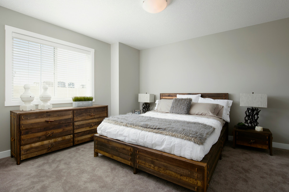This is an example of a medium sized traditional master bedroom in Calgary with beige walls and carpet.