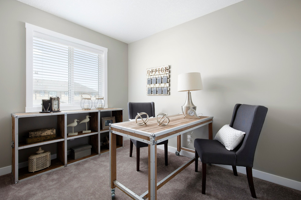 Medium sized traditional home office in Calgary with beige walls and carpet.