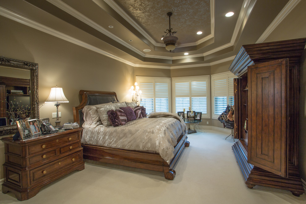 Large elegant master carpeted and beige floor bedroom photo in Other with gray walls
