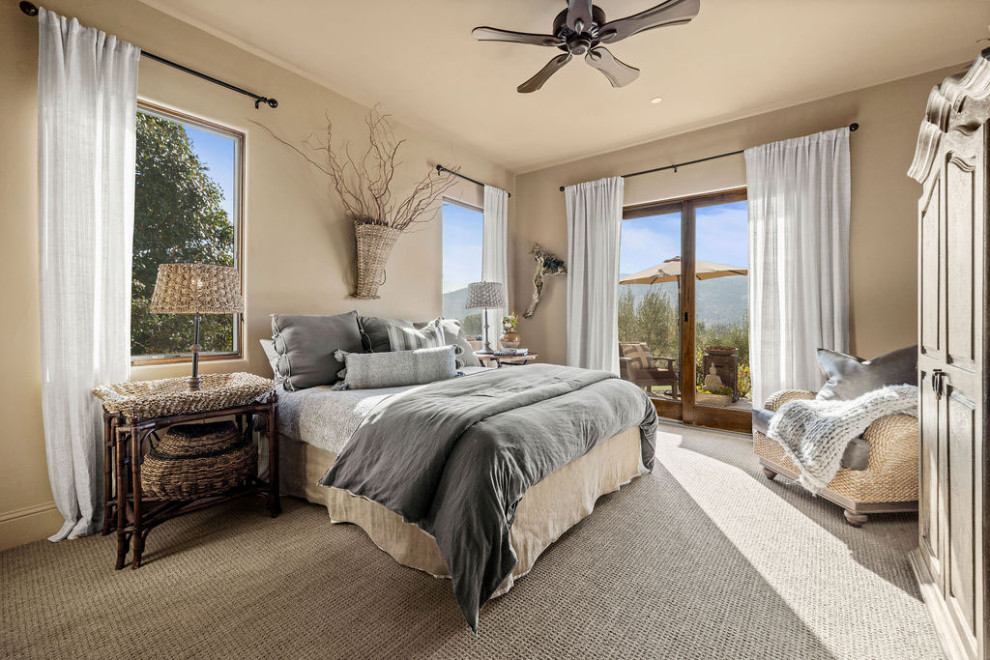 This is an example of a medium sized mediterranean master bedroom in San Francisco with beige walls, carpet and grey floors.