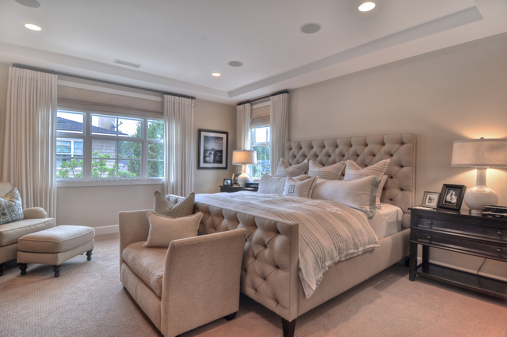 Design ideas for a traditional bedroom in Orange County with beige walls and carpet.