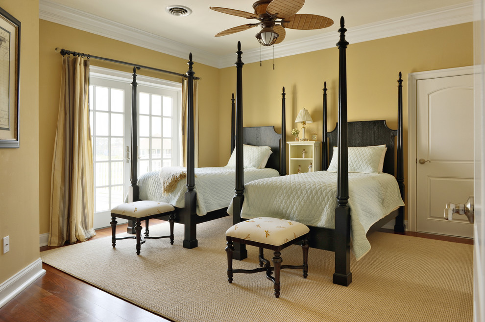 Elegant medium tone wood floor bedroom photo in Philadelphia with beige walls