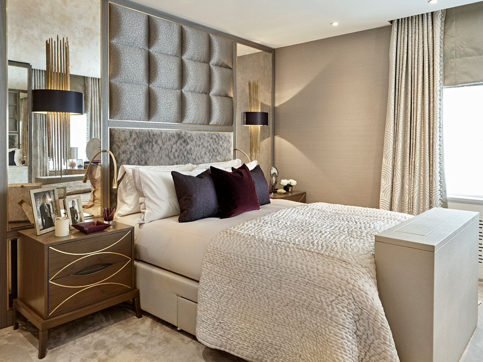 Medium sized traditional bedroom in London with beige walls, carpet and grey floors.