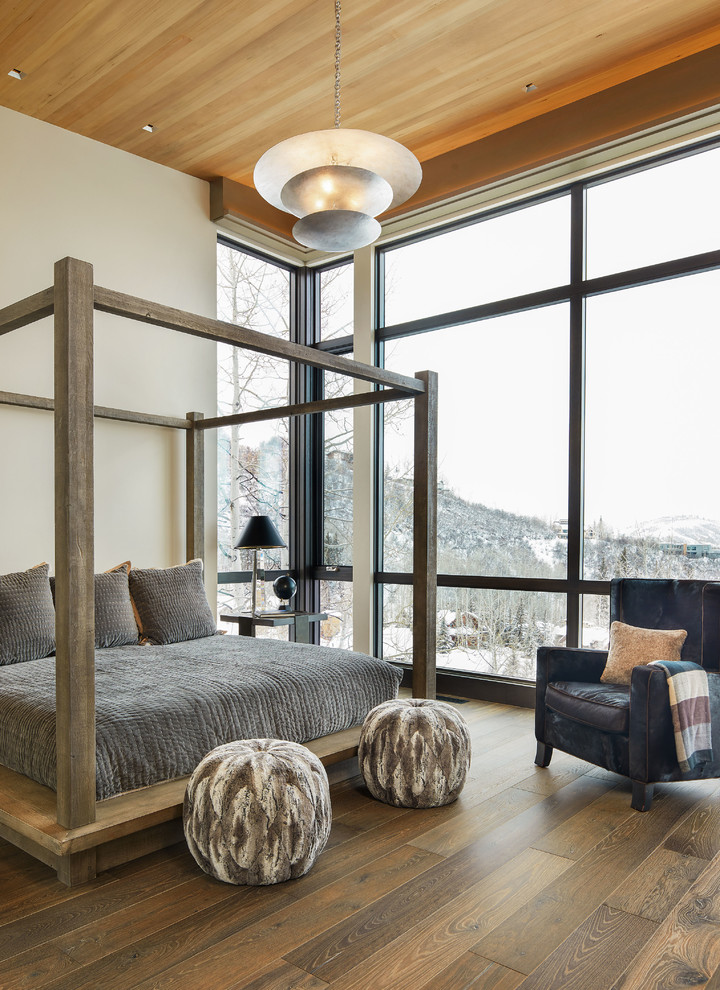 Large rustic master and grey and brown bedroom in Denver with beige walls, medium hardwood flooring, brown floors and no fireplace.