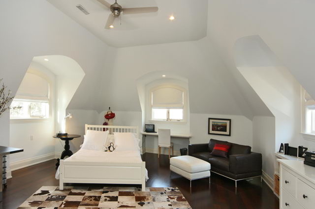 Large transitional guest medium tone wood floor bedroom photo in Toronto with white walls