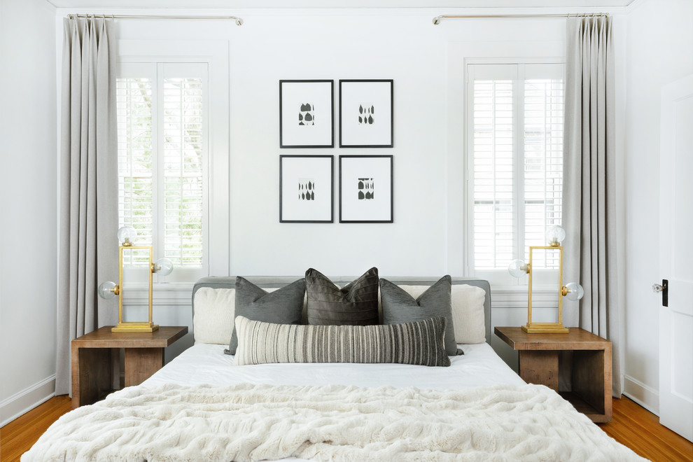 Inspiration for a contemporary master bedroom in Louisville with white walls, medium hardwood flooring and no fireplace.