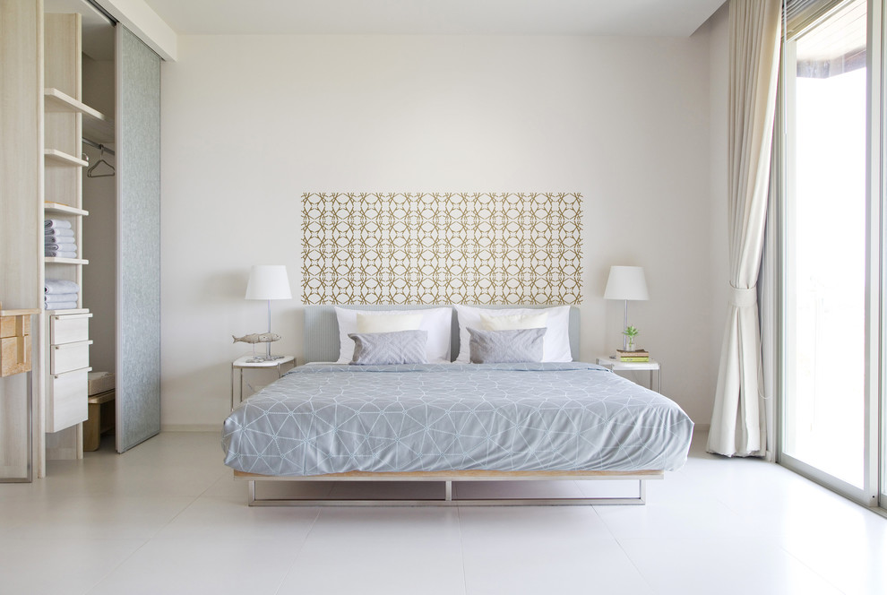 Inspiration for a modern master bedroom in New York with white walls and ceramic flooring.