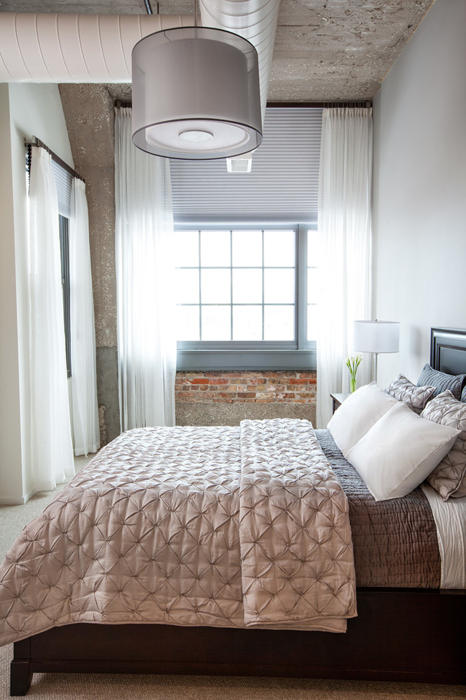 Example of an urban bedroom design in Chicago with white walls